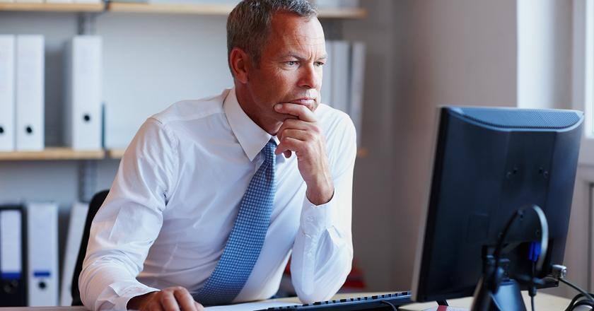 Insurance agent reading computer